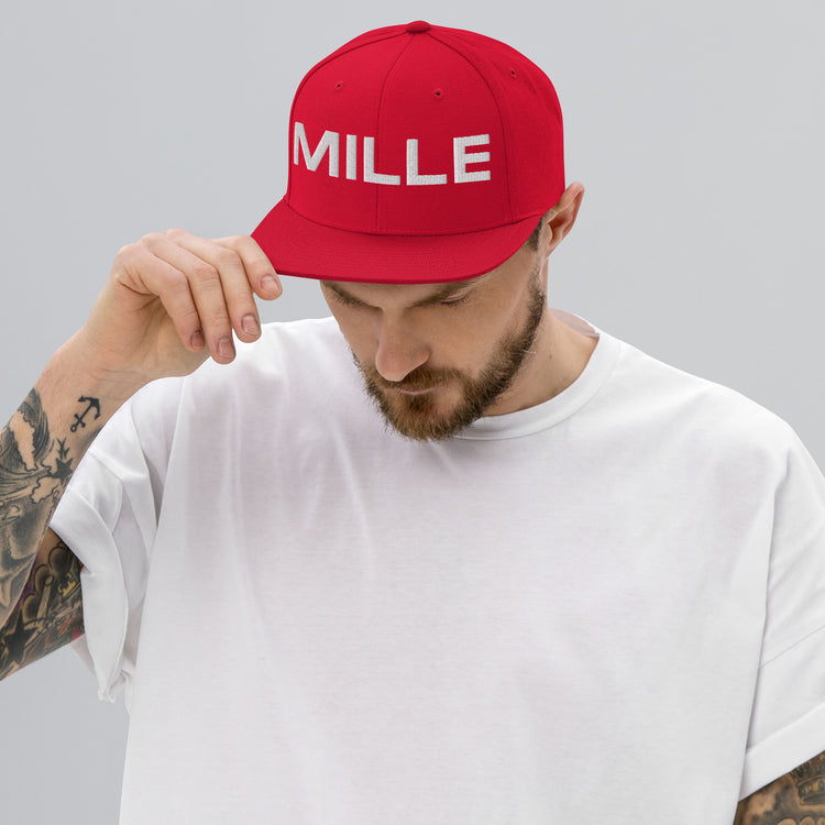Gorra Snapback MILLE INSIGNIA de color rojo con logo MILLE bordado en blanco. Vista frontal con modelo.