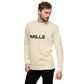 Sudadera MILLE Origin LS de color hueso con logo MILLE en el pecho. Vista frontal con modelo posando.```
